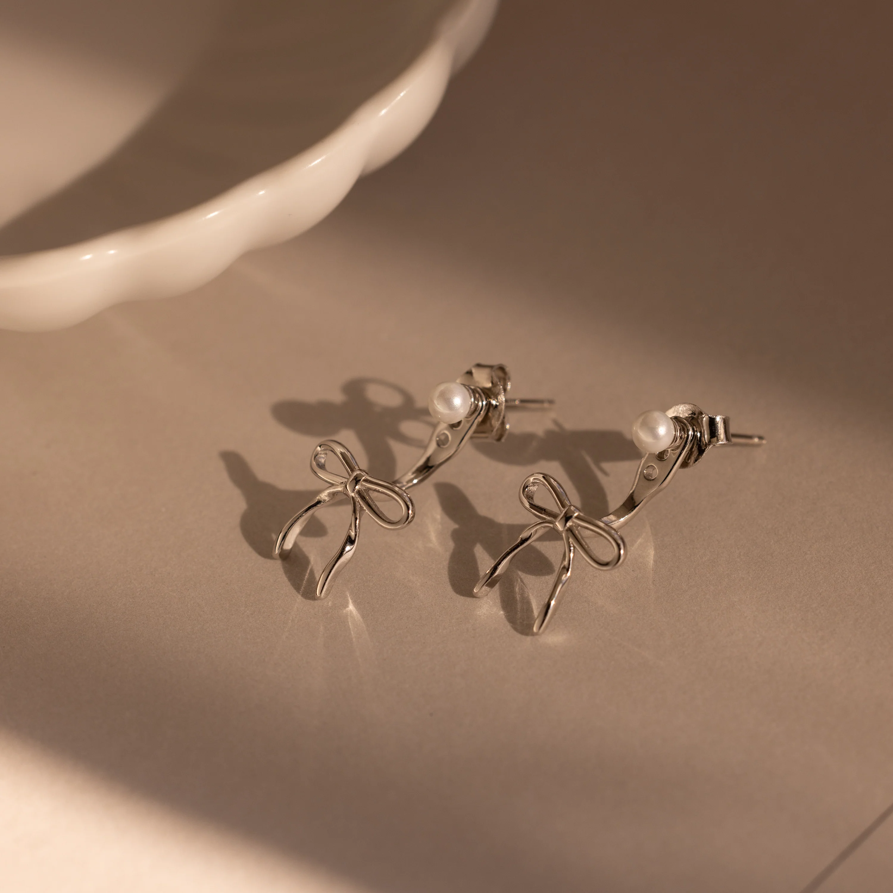 Pearl & Bow Ear Jackets in Silver